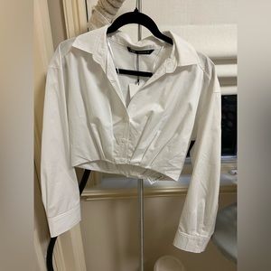It’s a white cropped Zara button up.